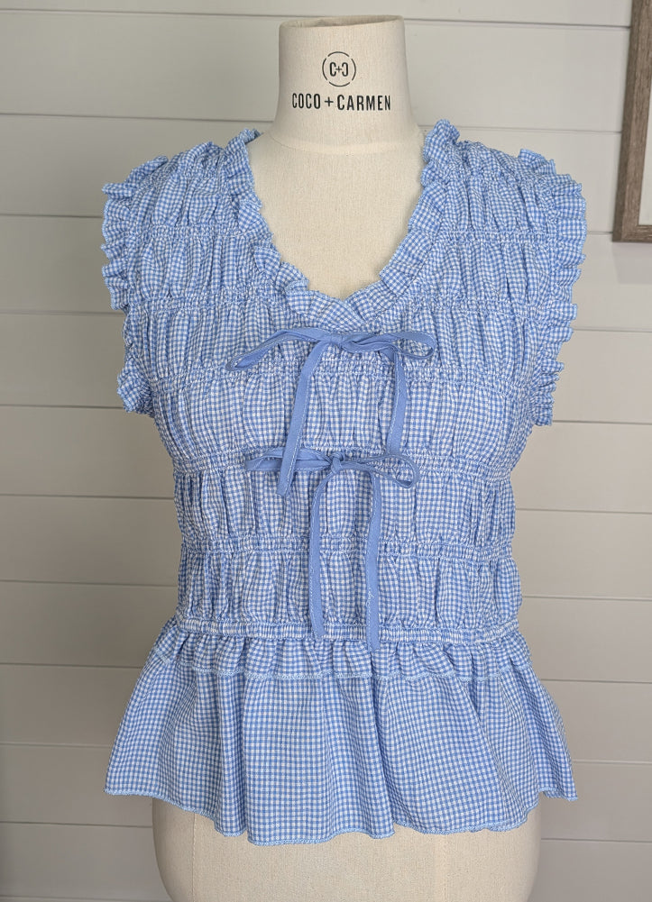 Mini Gingham Smocked V Neck Bow Tie Front Peplum Top in Chambray by Staccato